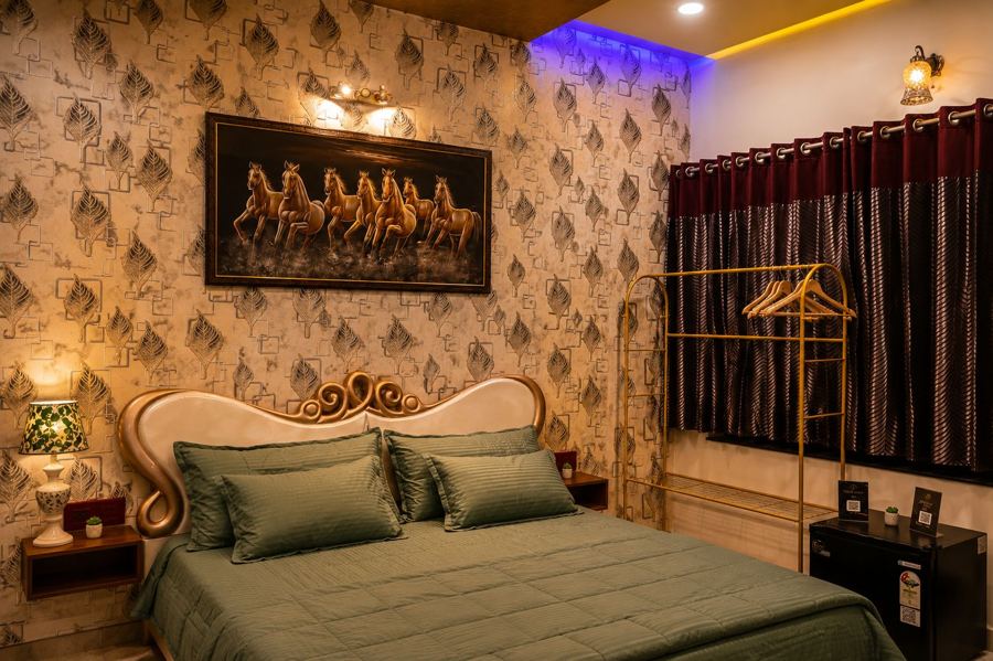 Master bedroom with green linen and a lit window garden