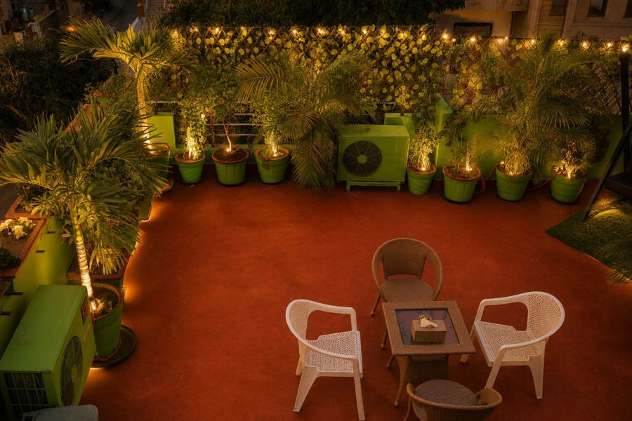 Rooftop terrace seating among potted palms